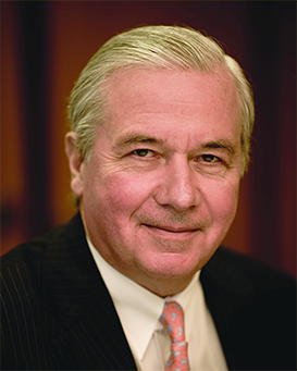 Jean-Paul Montupet, Assurant Board Member, dressed in a suit and tie and looking at the camera