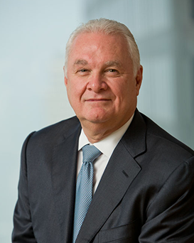 Juan N. Centro, Assurant Board Member, dressed in a suit and tie and looking at the camera